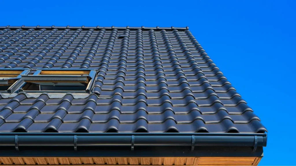 A clean dark gray tiled residential roof with an open skylight after a professional roof cleaning Wilmington NC soft wash service.