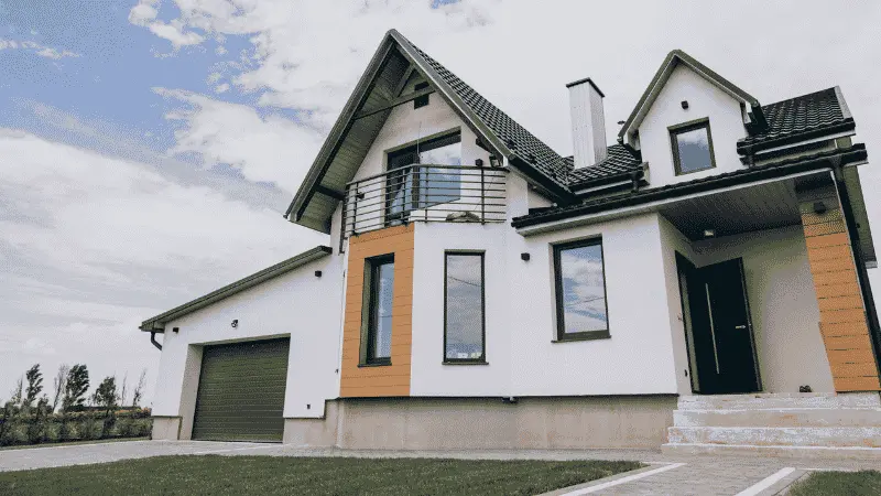 Modern two-story home with clean white siding and a spotless front walkway
