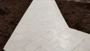 White tile sidewalk with stains and mud along the edges - Sidewalk Cleaning Wilmington, NC
