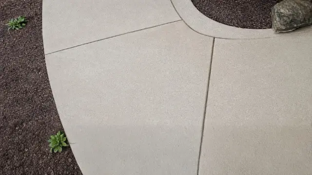 Curved concrete sidewalk next to landscaping