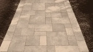 A gray stone paver walkway with clean joints and clear grout lines following a sidewalk cleaning Wilmington service.