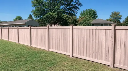Pink Wood Privacy Fence - Fence Cleaning Wilmington, NC Long wooden privacy fence along a green lawn