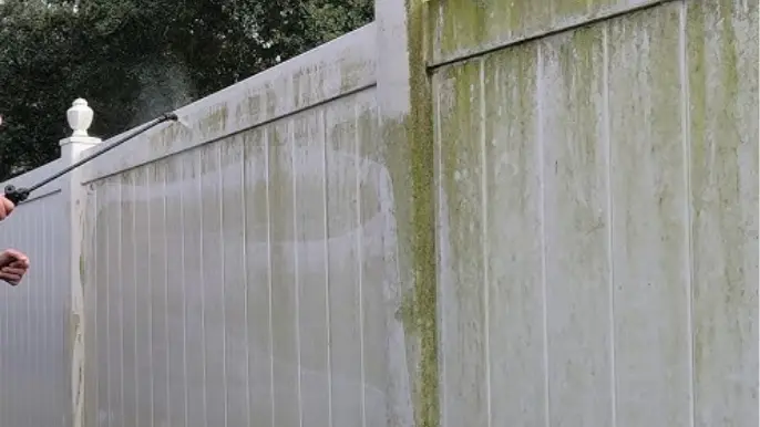 Vinyl Fence Algae Pressure Washing - Professional Pressure Washing Wilmington, NC Pressure washing green algae off a white vinyl privacy fence